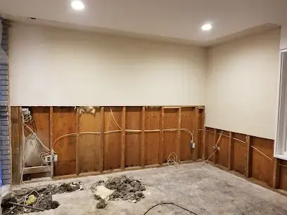 Lower drywall cut away to dry the wall cavities after a water loss